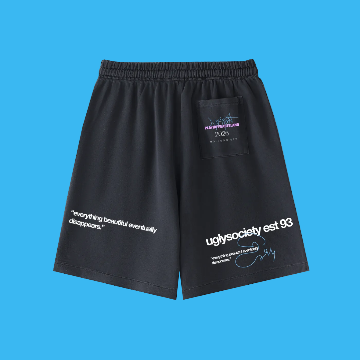 Black athletic shorts with white and blue graphic text and a small rectangular patch on the left thigh, shown on a plain white background.