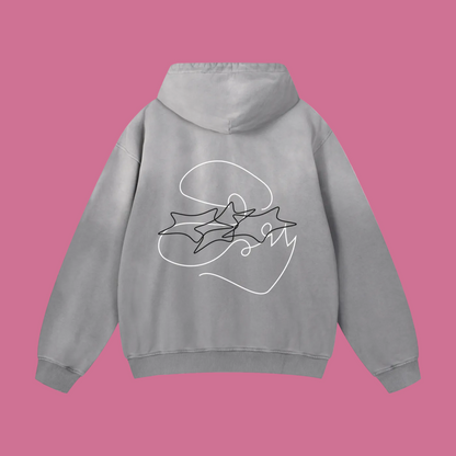 A light gray pullover hoodie shown from the back, featuring a white line art graphic of three stars inside a circle with the word 'SOM' written in cursive.