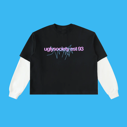 A black long-sleeve crop top layered over a white long-sleeve base, featuring a graphic print on the chest that reads 'uglysocietyest 93' in pink with blue line details, shown on a plain white background.
