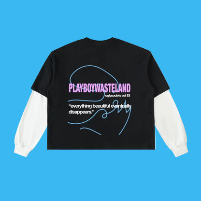 A black long-sleeve t-shirt with white sleeves, shown from the back. The back features a graphic print with the text 'PLAYBOYWASTELAND' in pink, a blue line-art signature, and a quote in white.