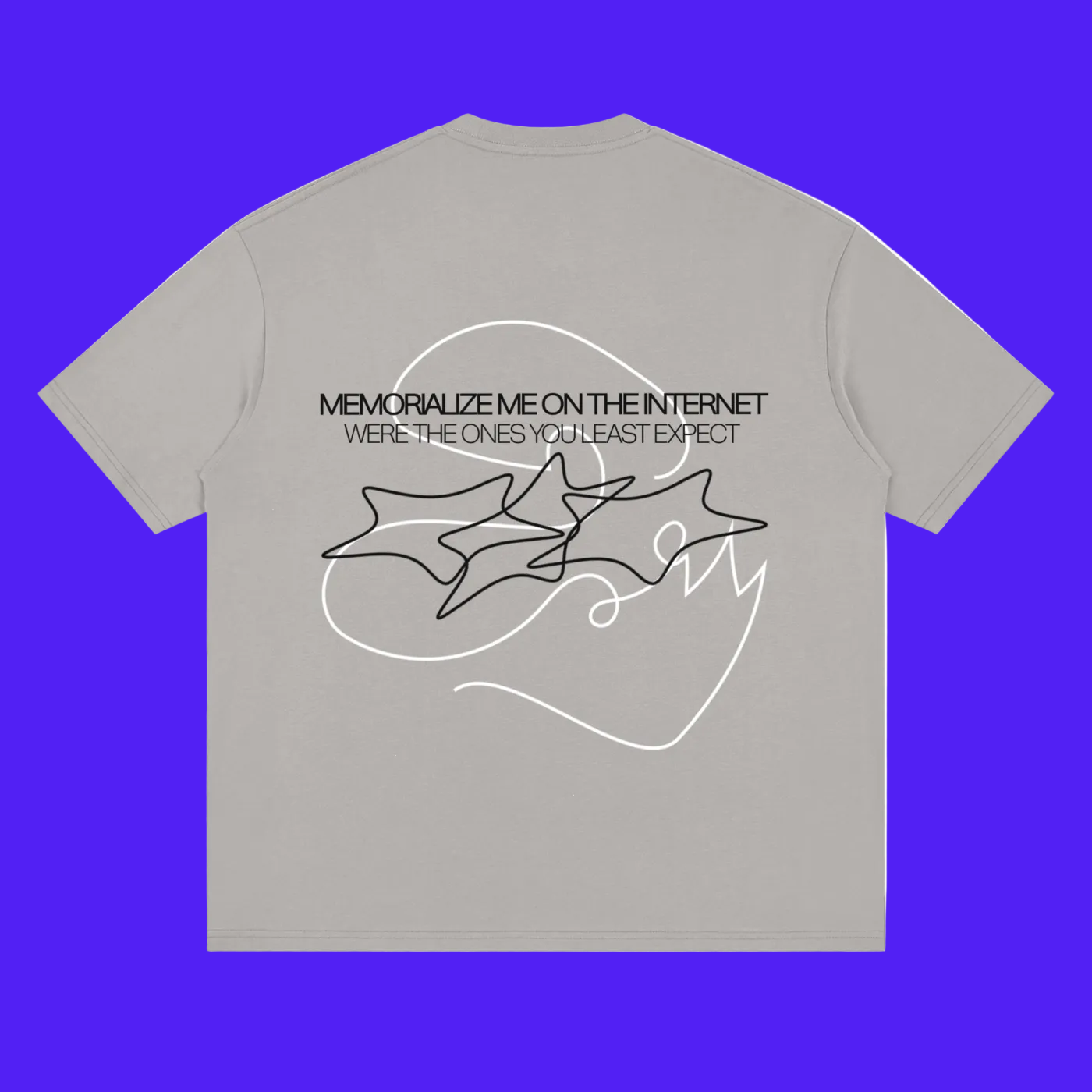 A light gray short-sleeve t-shirt with a black graphic print on the back. The graphic features the text 'MEMORIZE ME ON THE INTERNET' and 'WERE THE ONES YOU LEAST EXPECT' above a line-art illustration of three overlapping star-like shapes.